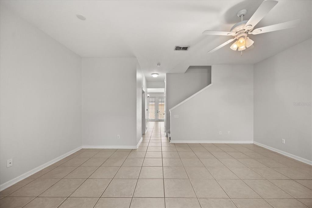 7719 Anselmo Lane Windermere, FL 34786 - Photo 5 of 31 an empty room with a ceiling fan and a window