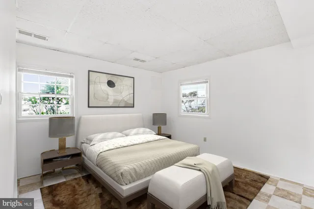 a bedroom with a bed and a lamp with window