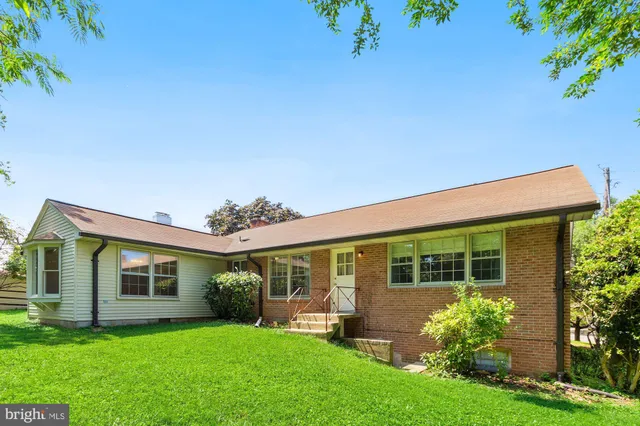 a front view of a house with a garden and yard