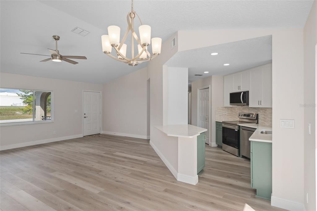 10352 Brentlawn Street Spring Hill, FL 34608 - Photo 11 of 35 a view of a kitchen with a sink wooden floor and staircase