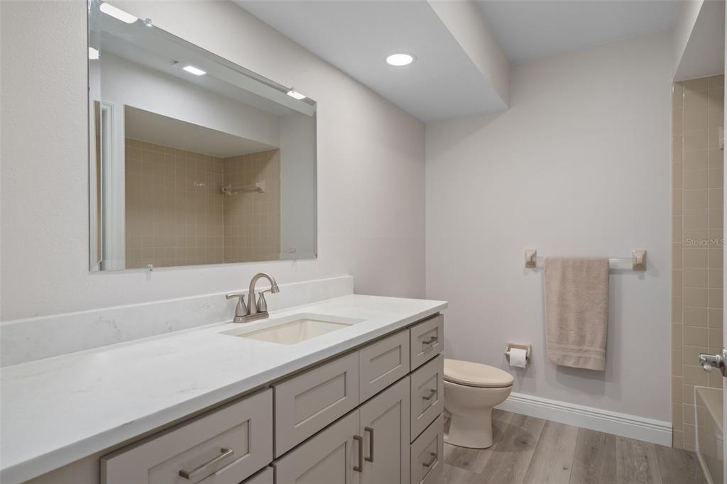 10352 Brentlawn Street Spring Hill, FL 34608 - Photo 19 of 35 a bathroom with a toilet a sink and mirror