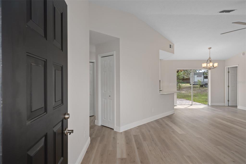10352 Brentlawn Street Spring Hill, FL 34608 - Photo 5 of 35 a view of a room with wooden floor fridge and windows