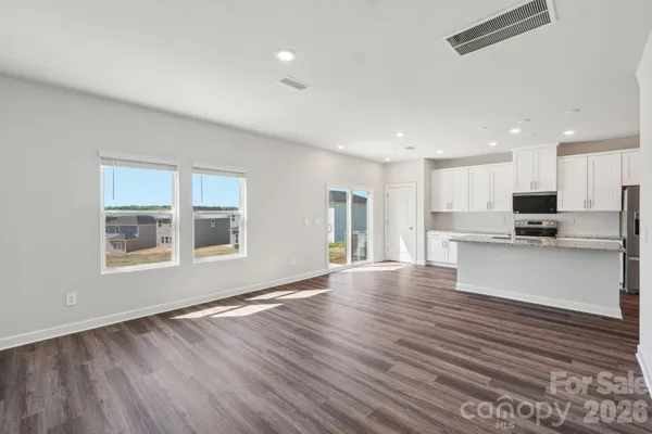 a view of kitchen with stainless steel appliances refrigerator oven and cabinets