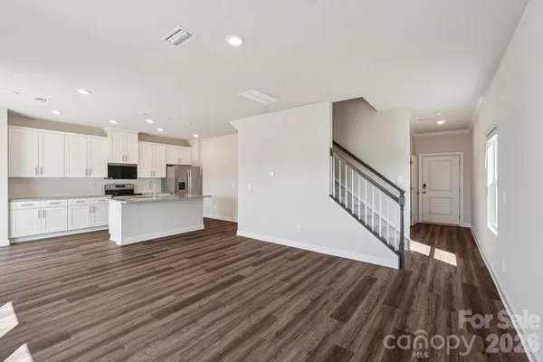 a view of kitchen with wooden floor and electronic appliances