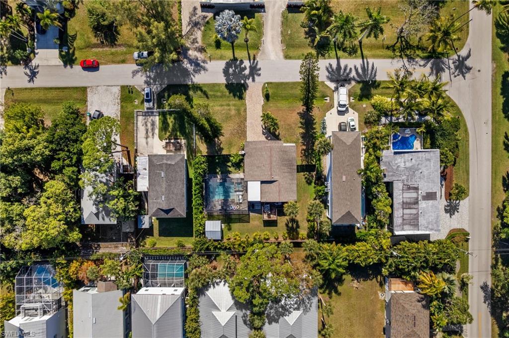 723 Park Avenue Naples, FL 34110 - Photo 15 of 48 an aerial view of a residential apartment building with swimming pool and lawn chairs