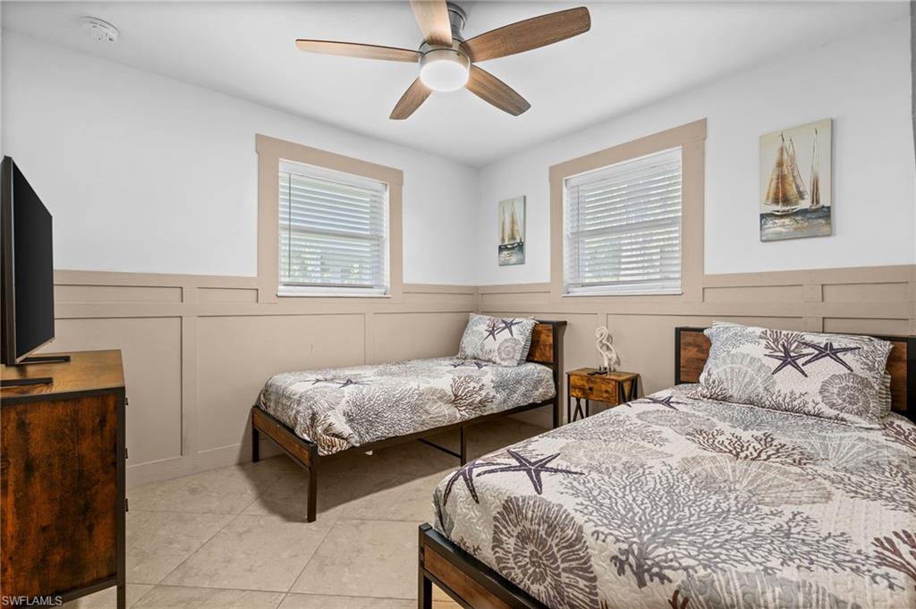 723 Park Avenue Naples, FL 34110 - Photo 16 of 48 a bedroom with two beds and a flat screen tv