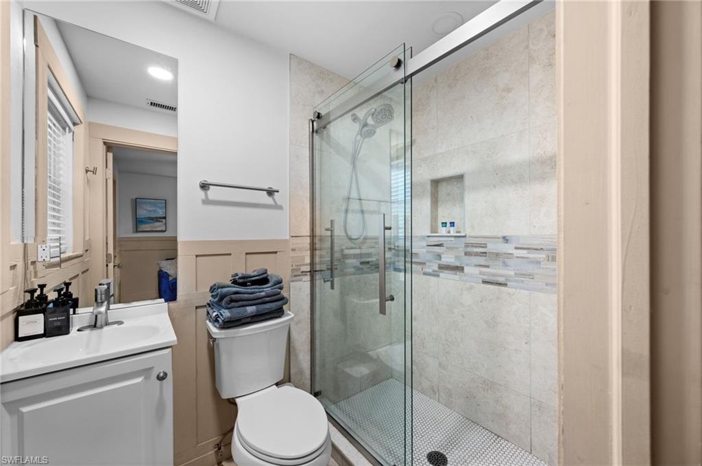 723 Park Avenue Naples, FL 34110 - Photo 21 of 48 a bathroom with a shower a sink a toilet and shower