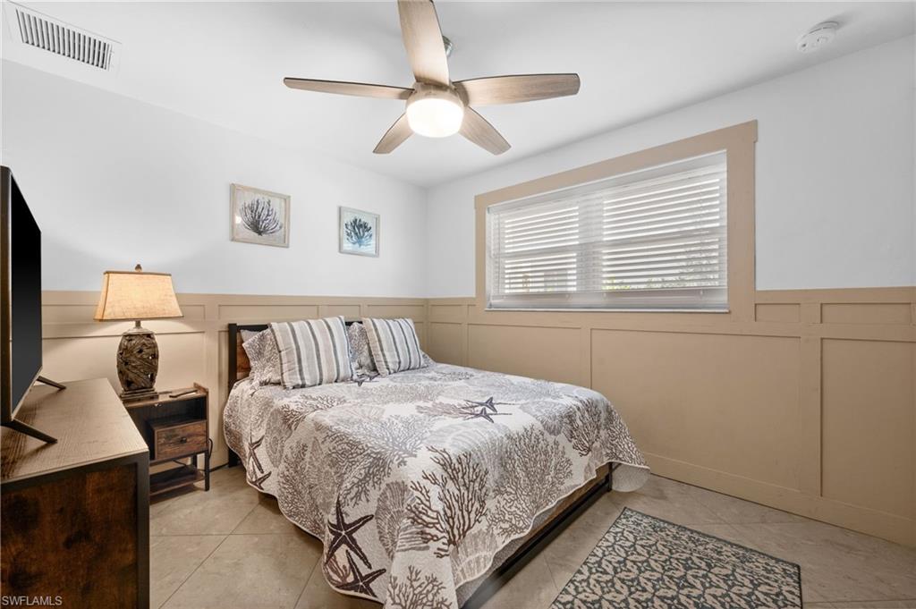 723 Park Avenue Naples, FL 34110 - Photo 23 of 48 a bedroom with a bed and window