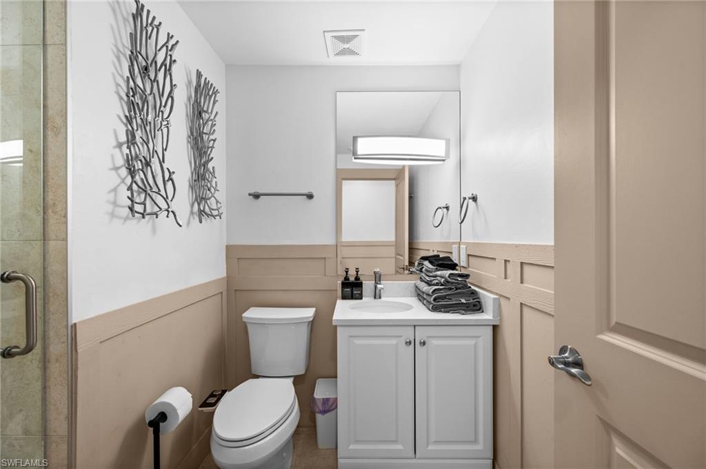 723 Park Avenue Naples, FL 34110 - Photo 26 of 48 a bathroom with a toilet sink and mirror