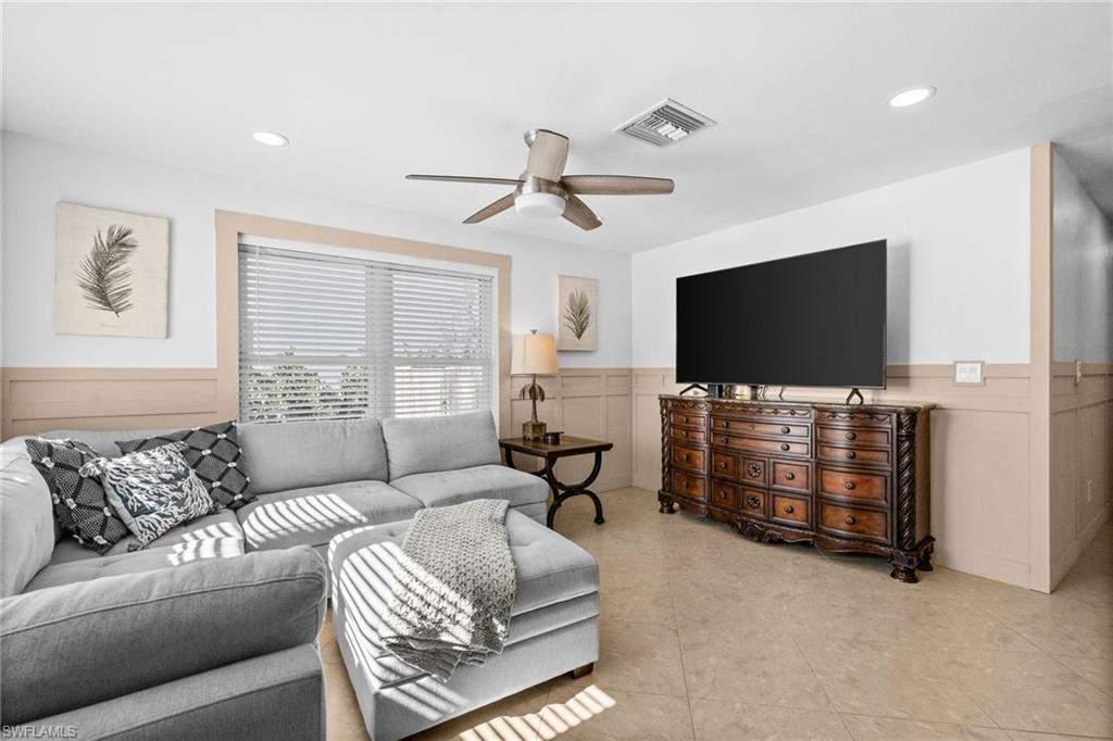 723 Park Avenue Naples, FL 34110 - Photo 29 of 48 a living room with furniture and a flat screen tv