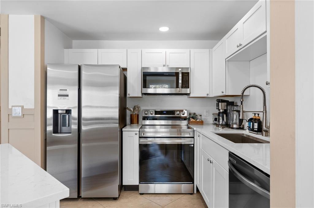 723 Park Avenue Naples, FL 34110 - Photo 32 of 48 a kitchen with a refrigerator stove and sink