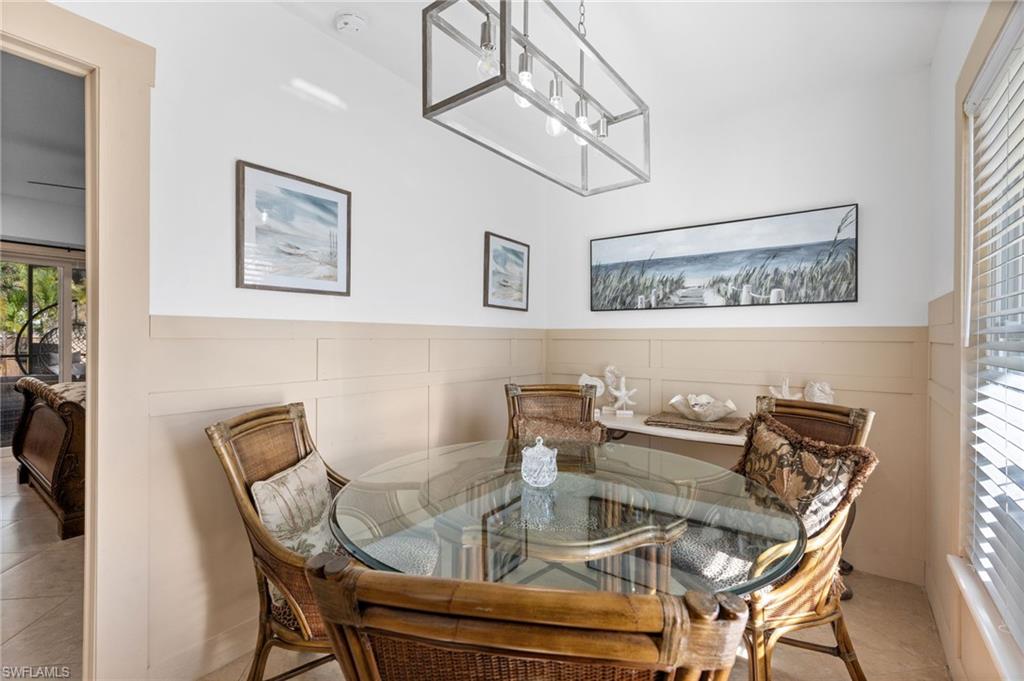 723 Park Avenue Naples, FL 34110 - Photo 37 of 48 a view of a dining room with furniture and chandelier