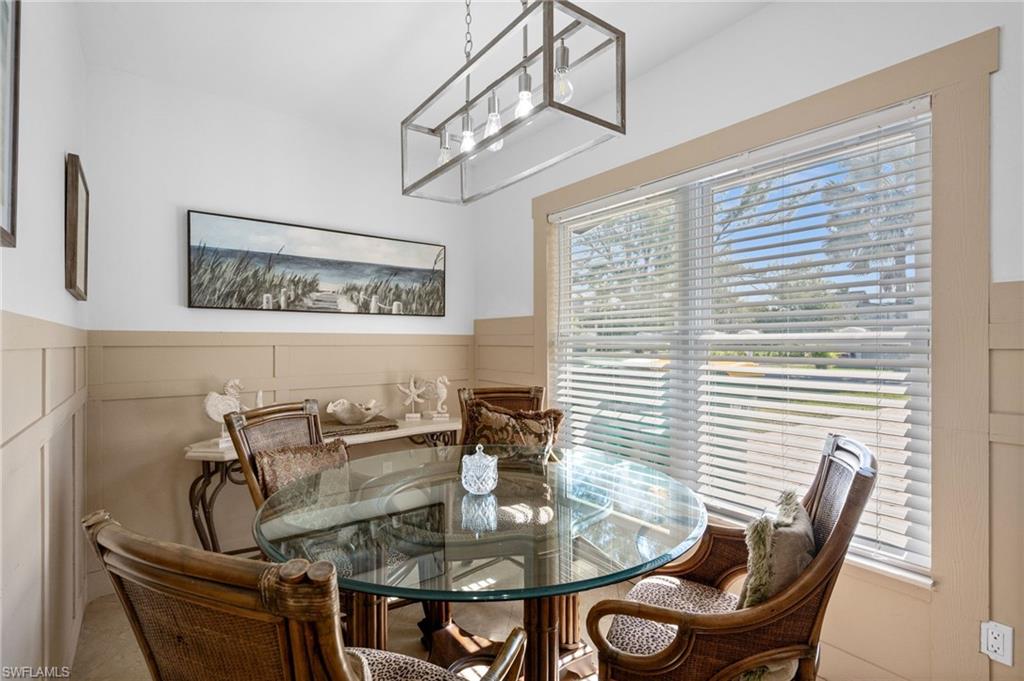 723 Park Avenue Naples, FL 34110 - Photo 38 of 48 a view of a dining room with furniture and chandelier