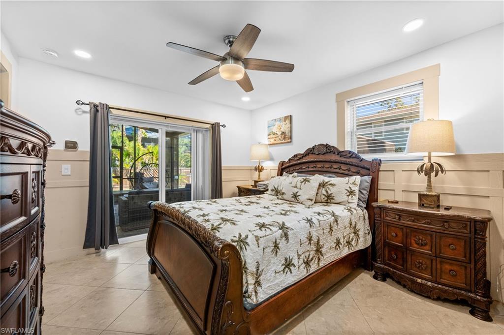 723 Park Avenue Naples, FL 34110 - Photo 39 of 48 a bedroom with a bed and a chandelier