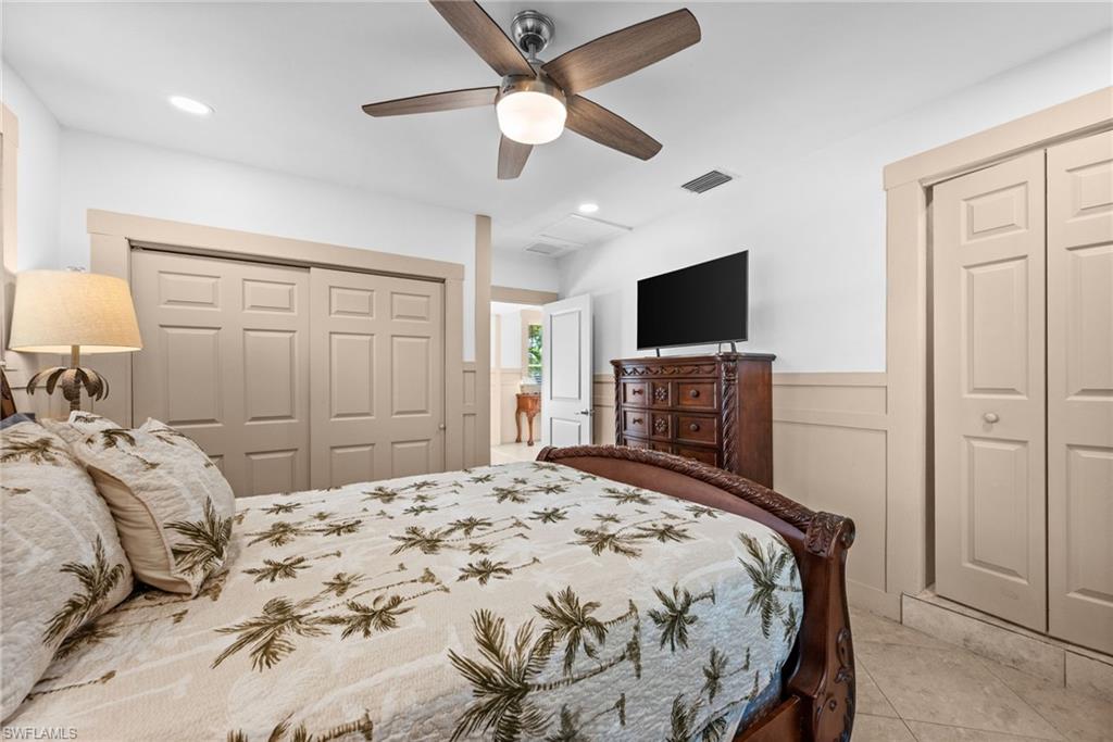 723 Park Avenue Naples, FL 34110 - Photo 40 of 48 a bedroom with a bed and a flat screen tv