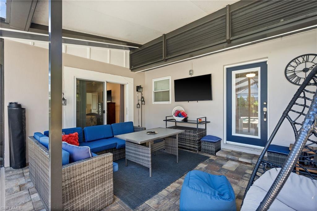 723 Park Avenue Naples, FL 34110 - Photo 44 of 48 a living room with furniture and a flat screen tv