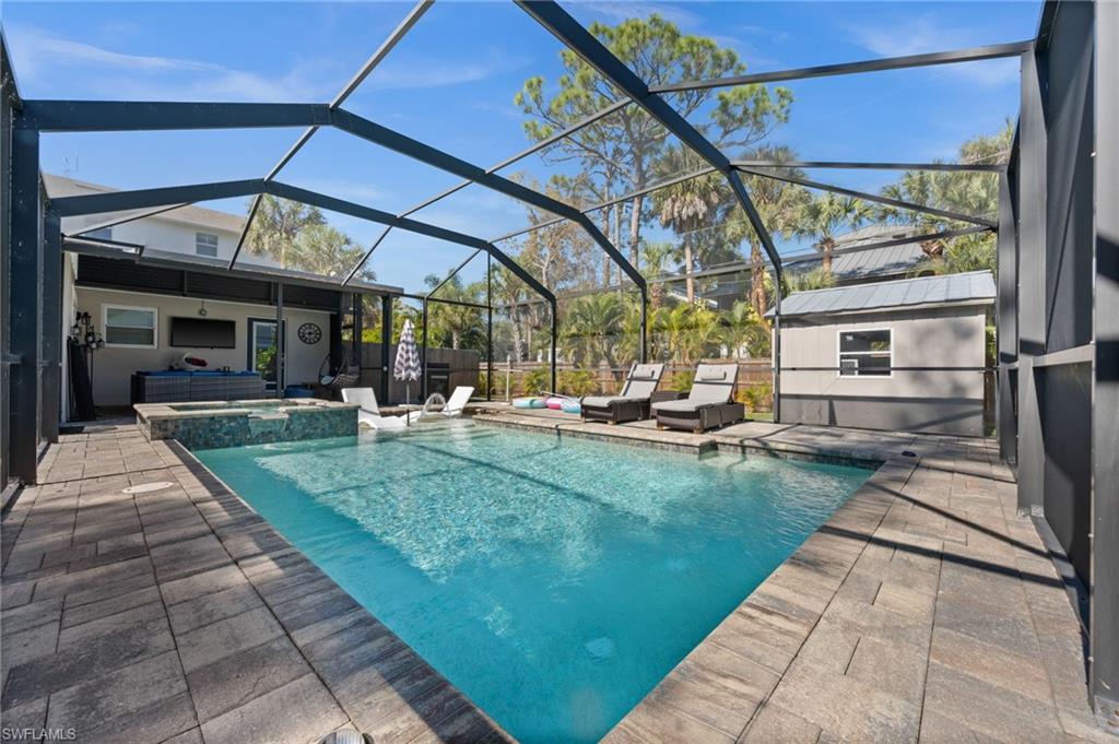 723 Park Avenue Naples, FL 34110 - Photo 45 of 48 a view of a swimming pool with a patio