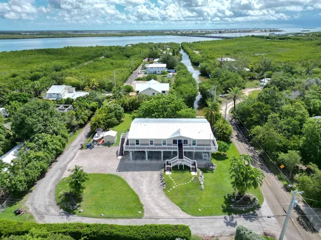 an aerial view of a house with garden space and street view