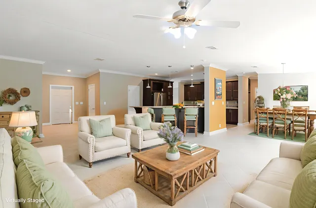 a living room with furniture and kitchen view