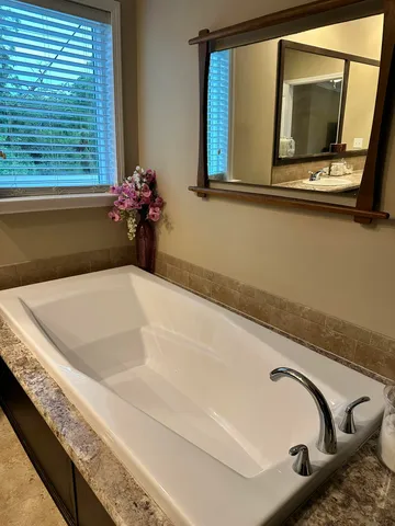 a bath tub sitting next to a window