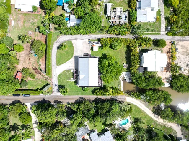 an aerial view of a house with a yard and garden
