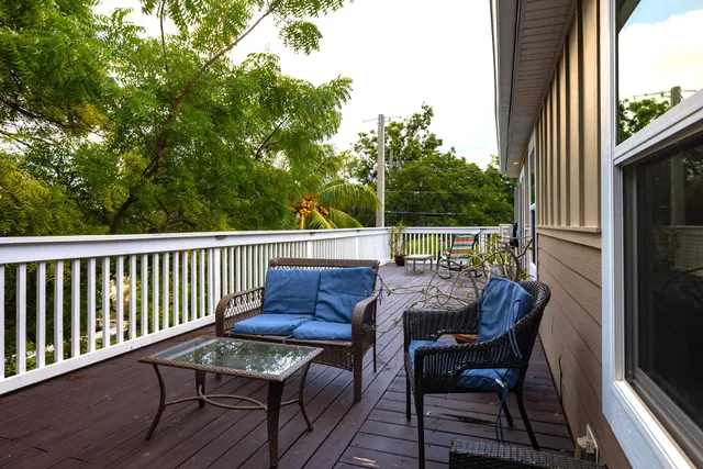 a view of a chairs and table in the balcony