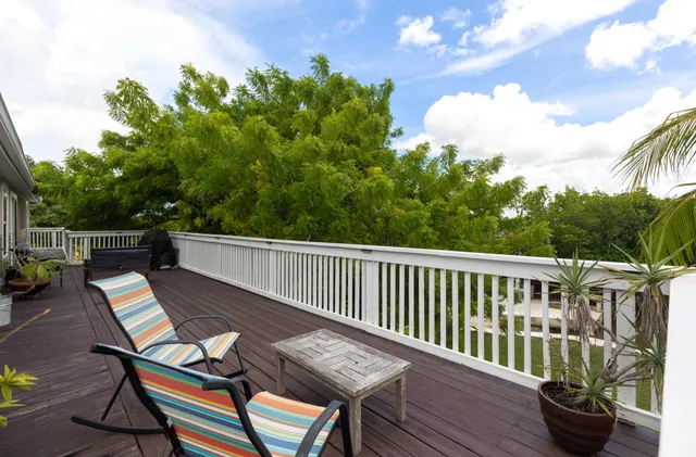 a view of a chairs and table on the deck