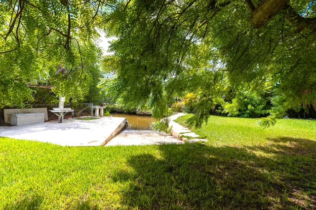 a view of a backyard with swimming pool