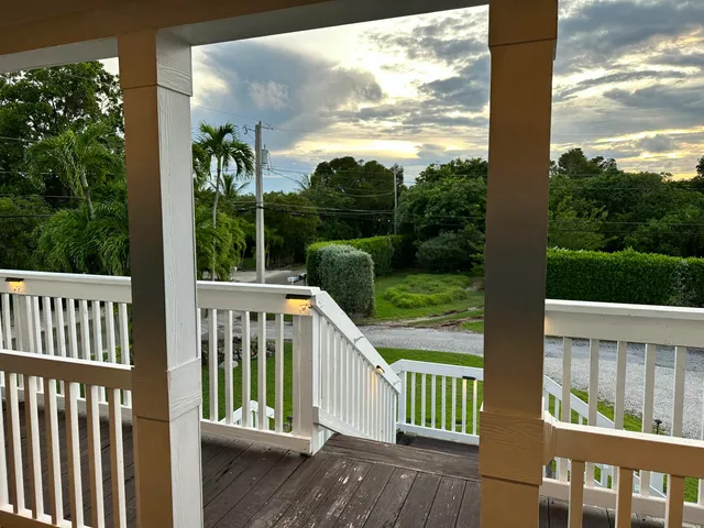 a view of a deck with a floor to ceiling window