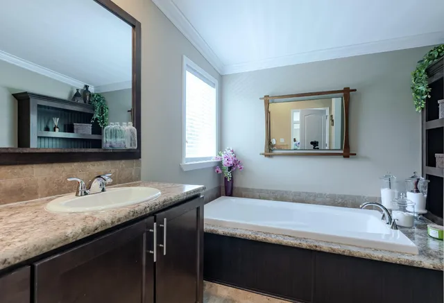 a bathroom with a granite countertop sink a mirror and a
