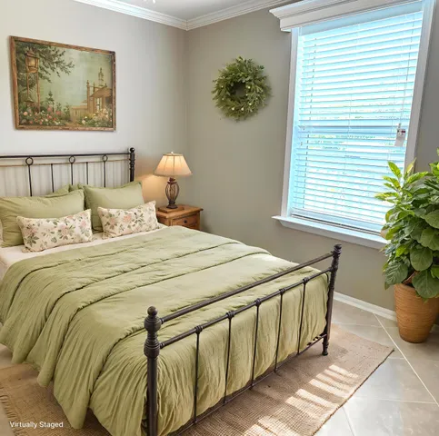 a bedroom with a bed and a potted plant