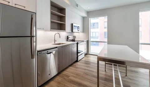 a kitchen with stainless steel appliances a refrigerator and a sink