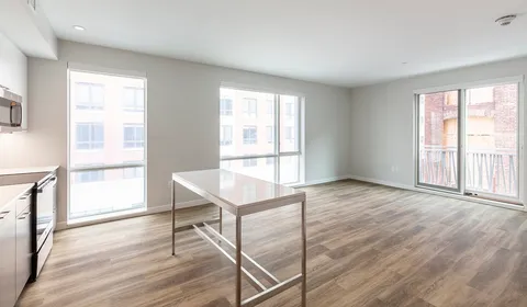 a view of a room with wooden floor and windows