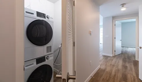 a view of a hallway with washer and dryer
