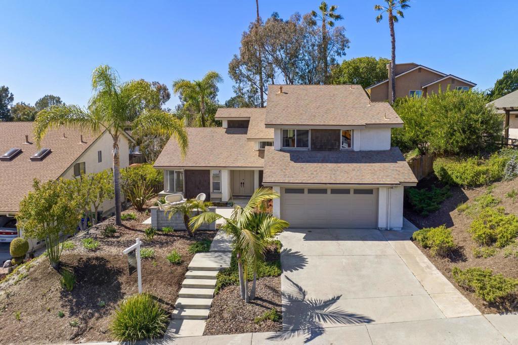 a aerial view of a house with a yard and potted plants
