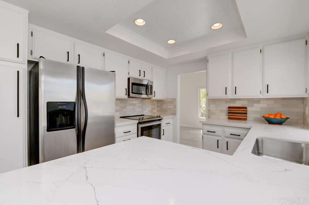 3573 Evening Canyon Road Oceanside, CA 92056 - Photo 12 of 45 a kitchen with stainless steel appliances a refrigerator sink stove microwave and cabinets