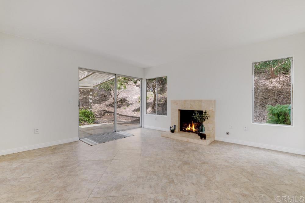 3573 Evening Canyon Road Oceanside, CA 92056 - Photo 13 of 45 a view of an empty room with a fireplace and a window
