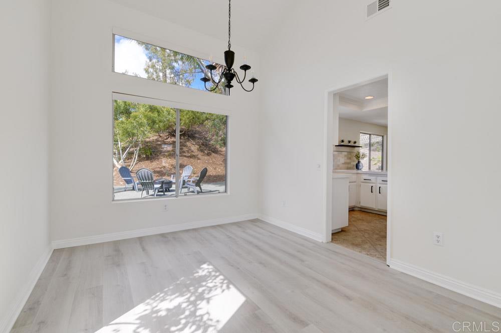 3573 Evening Canyon Road Oceanside, CA 92056 - Photo 6 of 45 wooden floor in an empty room with a window