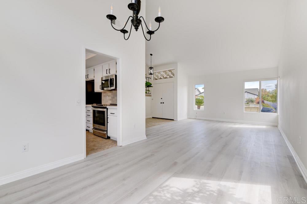 3573 Evening Canyon Road Oceanside, CA 92056 - Photo 7 of 45 a view of empty room with wooden floor and window