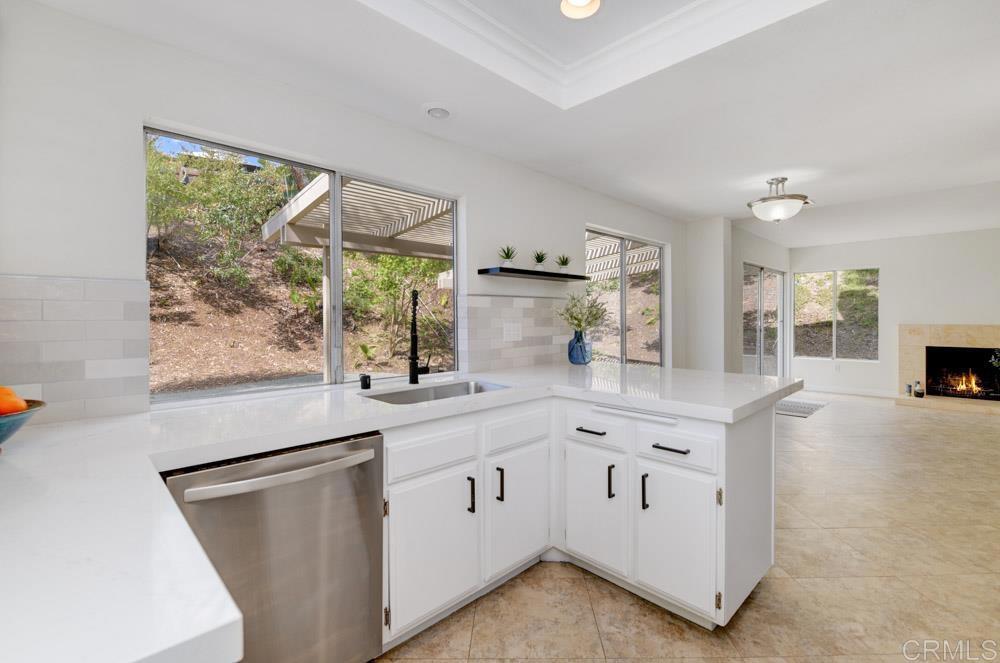 3573 Evening Canyon Road Oceanside, CA 92056 - Photo 8 of 45 a kitchen with white cabinets and window