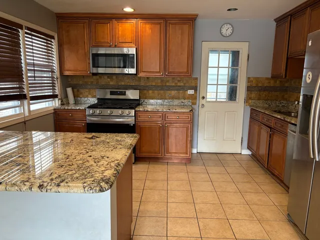 a kitchen with a stove a microwave and a counter space