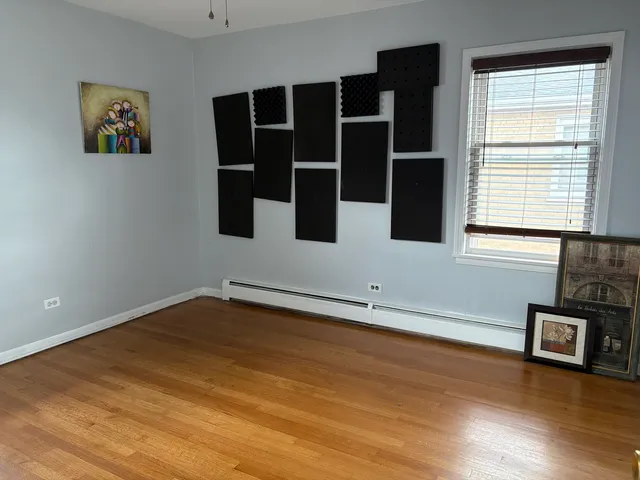 a view of a room with an empty space and wooden floor