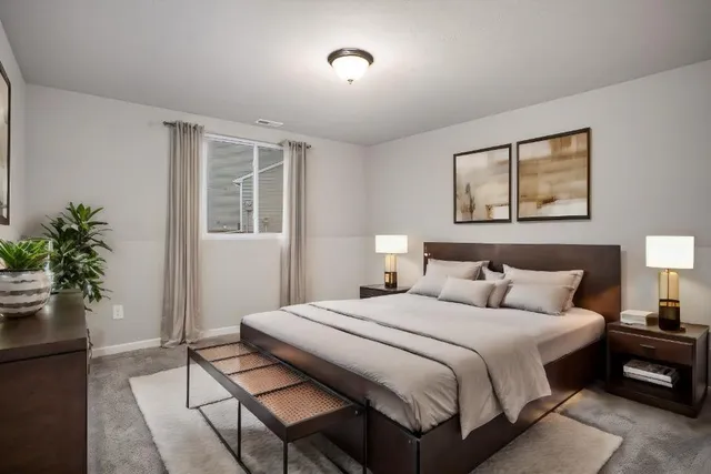 a bedroom with a bed and a potted plant