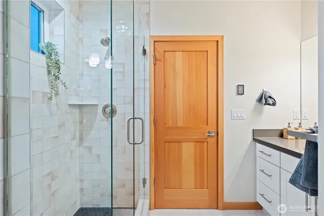 a bathroom with a shower and a sink