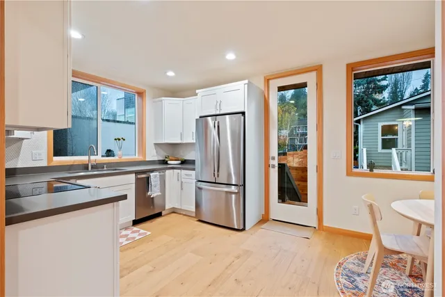 a kitchen with a refrigerator and furniture