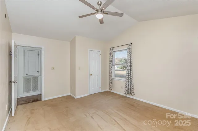 a view of a big room with closet area and ceiling fan