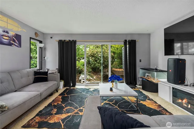 a living room with furniture large window and a flat screen tv