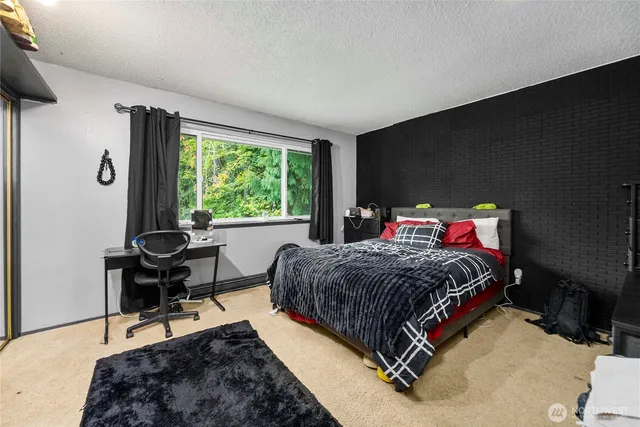 a bedroom with a bed and a table in it