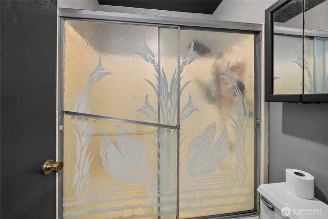 a bathroom with a glass shower door