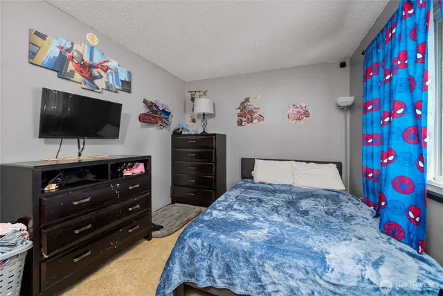 a bedroom with a bed and flat screen tv